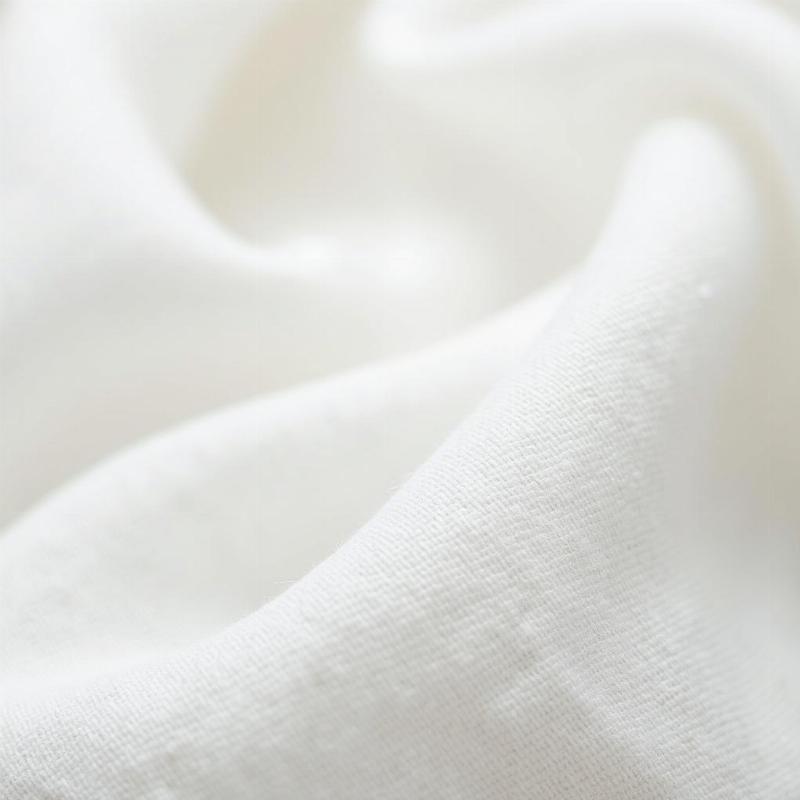 Hình ảnh cận cảnh cấu trúc dệt thưa, thoáng khí của vải Muslin cotton tự nhiên.